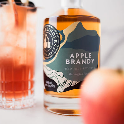 bass & Flinders distillery Apple Brandy bottle with a tall glass of brandy cocktail and an apple in the background