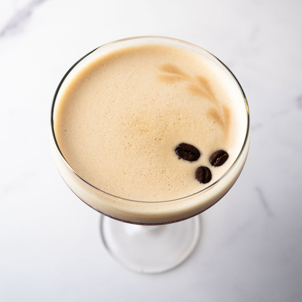 Bass& Flinders Distillery Eau De Vie Espresso Martini Cocktail with coffee beans in a coupe glass on a white background