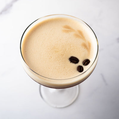 Bass& Flinders Distillery Eau De Vie Espresso Martini Cocktail with coffee beans in a coupe glass on a white background