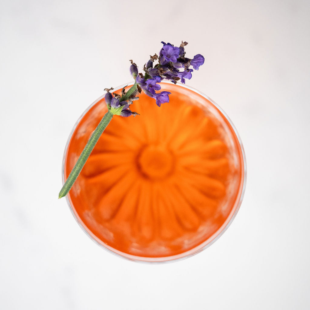 bass and flinders distillery Orange mistelle cocktail with lavender garnish on a white background